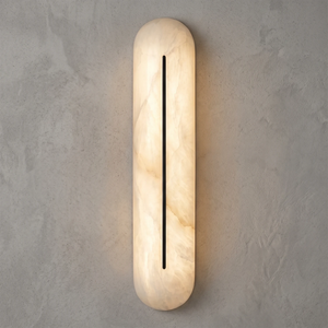 Front view of a Hoailamp black-slotted alabaster linear wall sconce illuminated with a warm glow