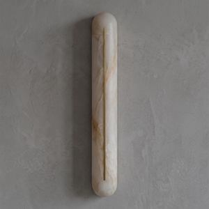 Front view of a Hoailamp brass-slotted alabaster linear wall sconce with a warm golden glow