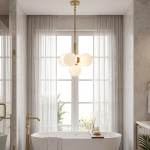 Lune chandelier illuminated above a freestanding bathtub beside a window