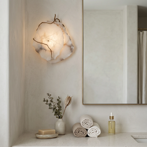 Hand-carved alabaster wall sconce with warm glow, modern bathroom lighting, natural stone texture