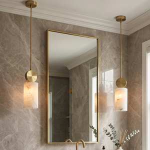 Pair of alabaster mini pendants flanking a vanity mirror in a dry powder room