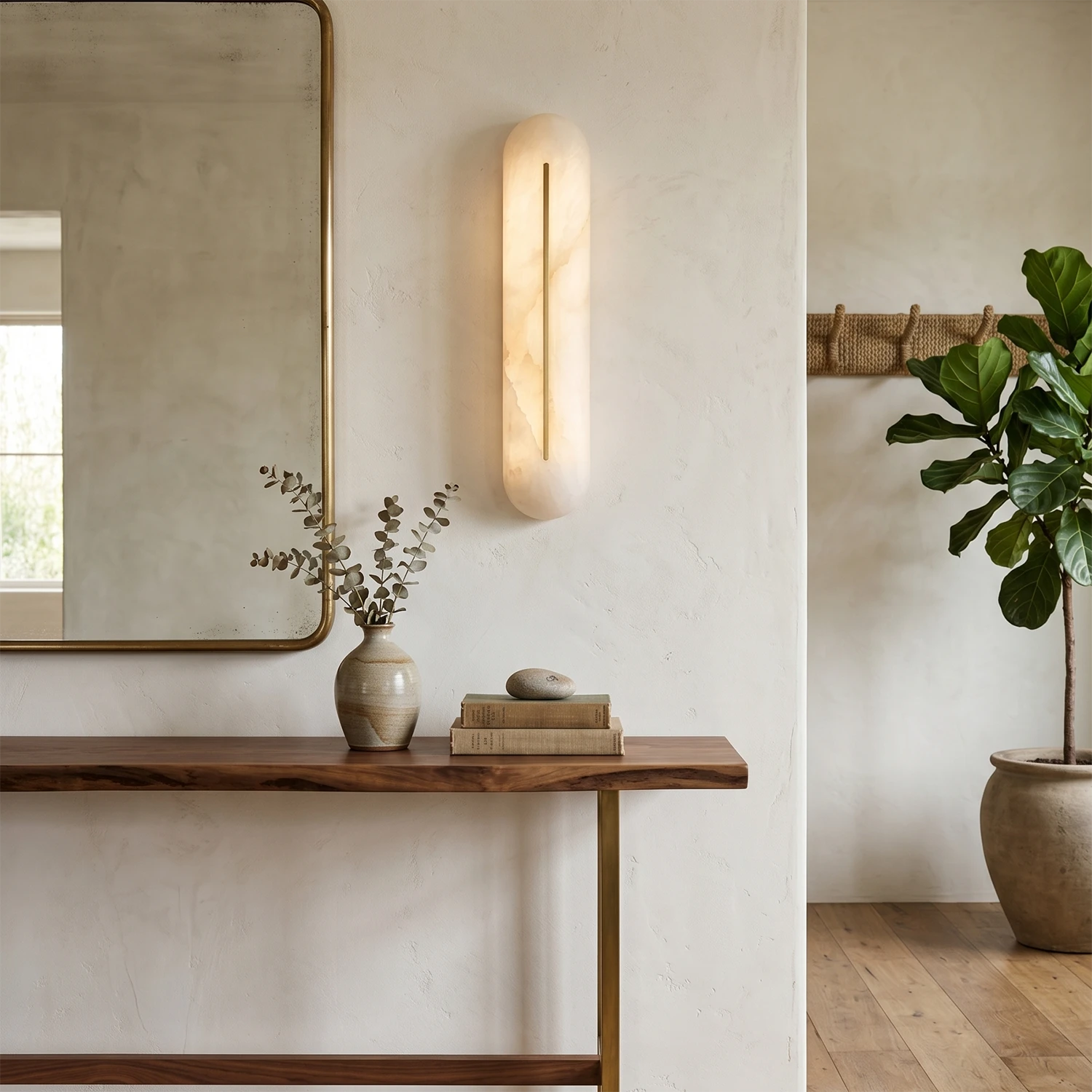 Single Hoailamp alabaster linear wall sconce above a foyer hallway console table