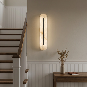 Alabaster linear LED wall sconce by Hoailamp illuminating a staircase landing beside wooden stairs
