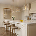 Auric Round Pendant Light by Hoailamp - White marble kitchen island with French-molding wall