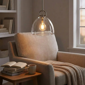 Auric Round Pendant Light by Hoailamp - Light accent reading chair with walnut bookshelf background