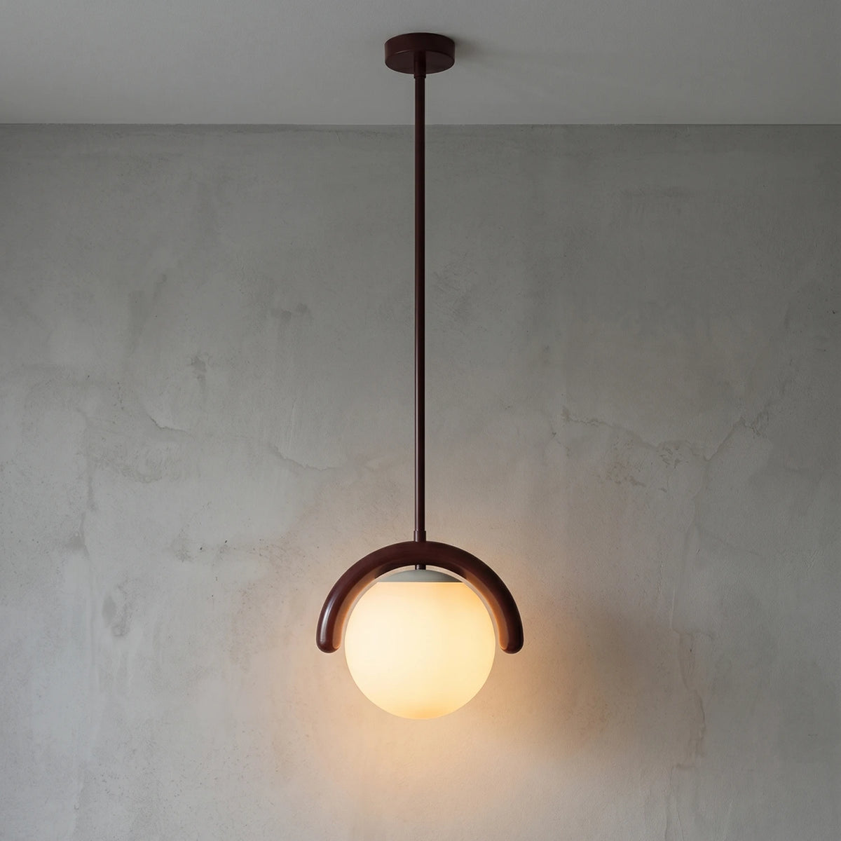 Curved Linear Opal Globe Pendant - Reddish Brown Single Globe Illuminated Glow | HoaiLamp