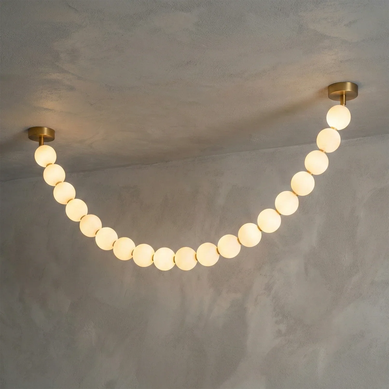 Dazzling Pearl Necklace Chandelier - Studio Grey Concrete Backdrop Single Strand Wide Drape Lit | HoaiLamp