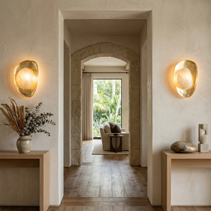 Hand crafted hammered metal lotus leaf wall sconce on symmetrical hallway walls