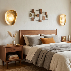 Hand crafted hammered metal lotus leaf wall sconce above walnut nightstand