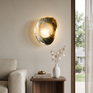 Hand crafted hammered metal lotus leaf wall sconce on walnut side table
