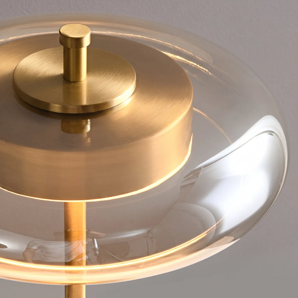Top angle view of the brass cap and disc held inside the glass halo.