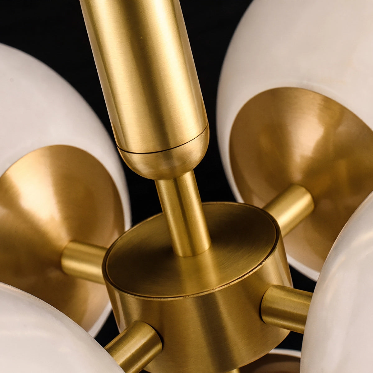 Close-up of the Lune brass center hub, arms and suspension rod