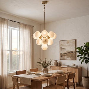 Illuminated Lune chandelier above a rectangular wooden dining table