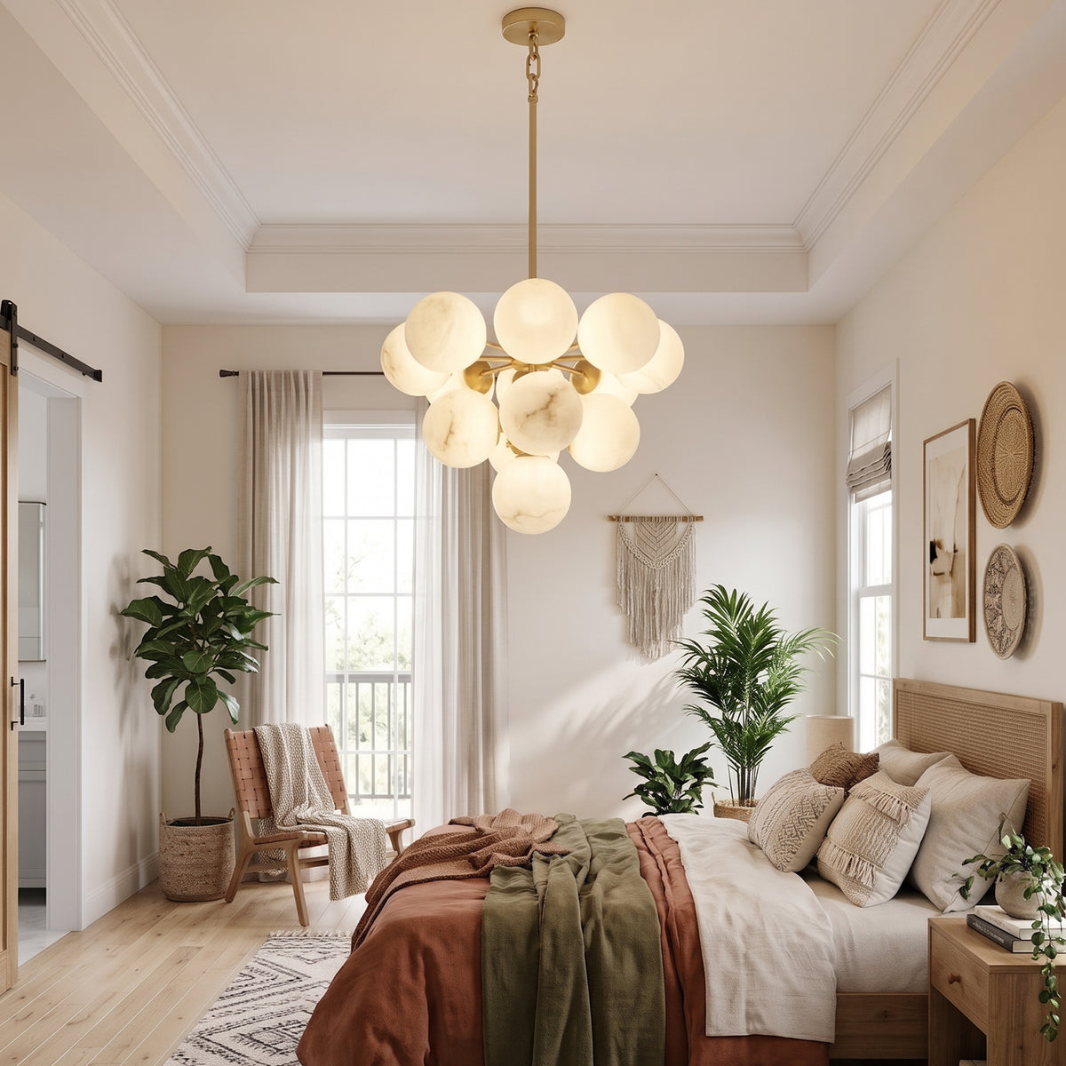 Illuminated Lune chandelier above a bed in a bright bedroom