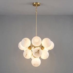 Illuminated medium Lune chandelier suspended from a brass rod