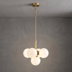 Illuminated small Lune chandelier suspended from a brass rod