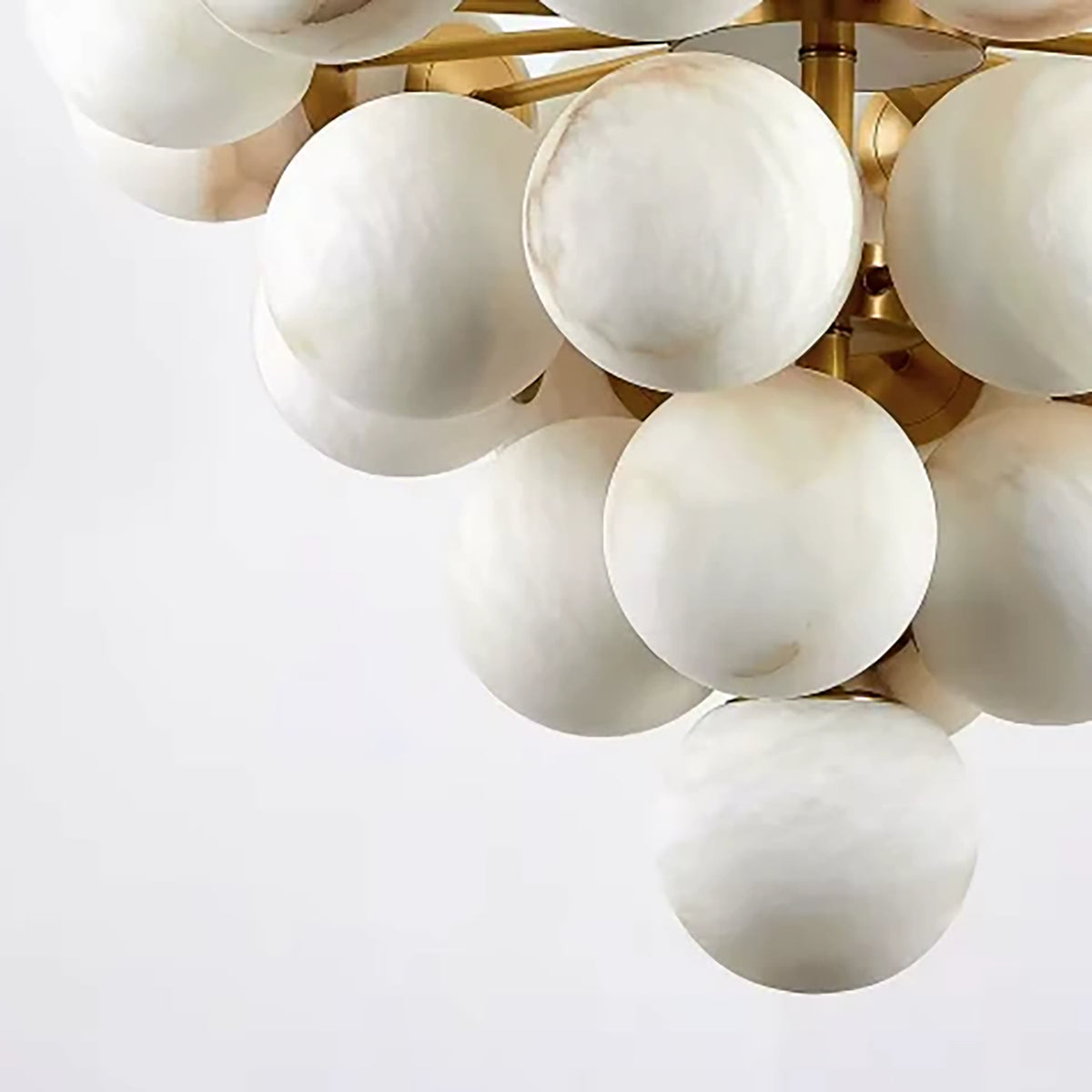 Close-up of unlit Lune alabaster globes arranged in tiers