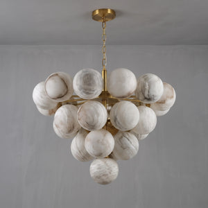Unlit large Lune chandelier suspended from a brass chain