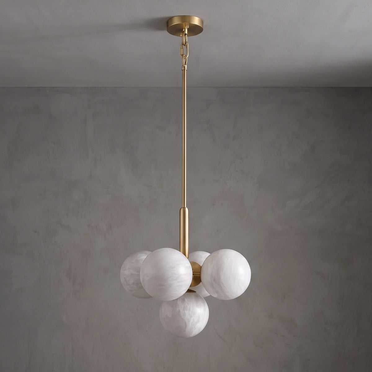 Unlit small Lune chandelier with alabaster globes and a brass suspension rod