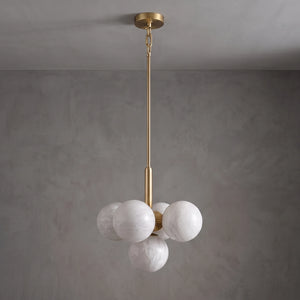 Unlit small Lune chandelier with alabaster globes and a brass suspension rod