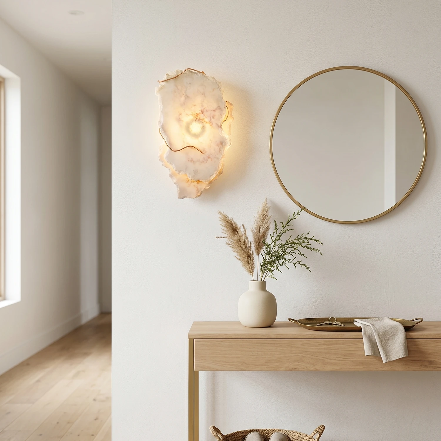Hand-carved alabaster wall sconce with warm glow, modern minimalist entryway decor