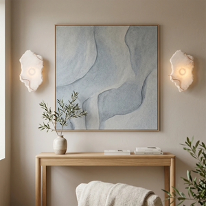 Hand-carved alabaster wall sconces with warm glow, modern minimalist entryway lighting