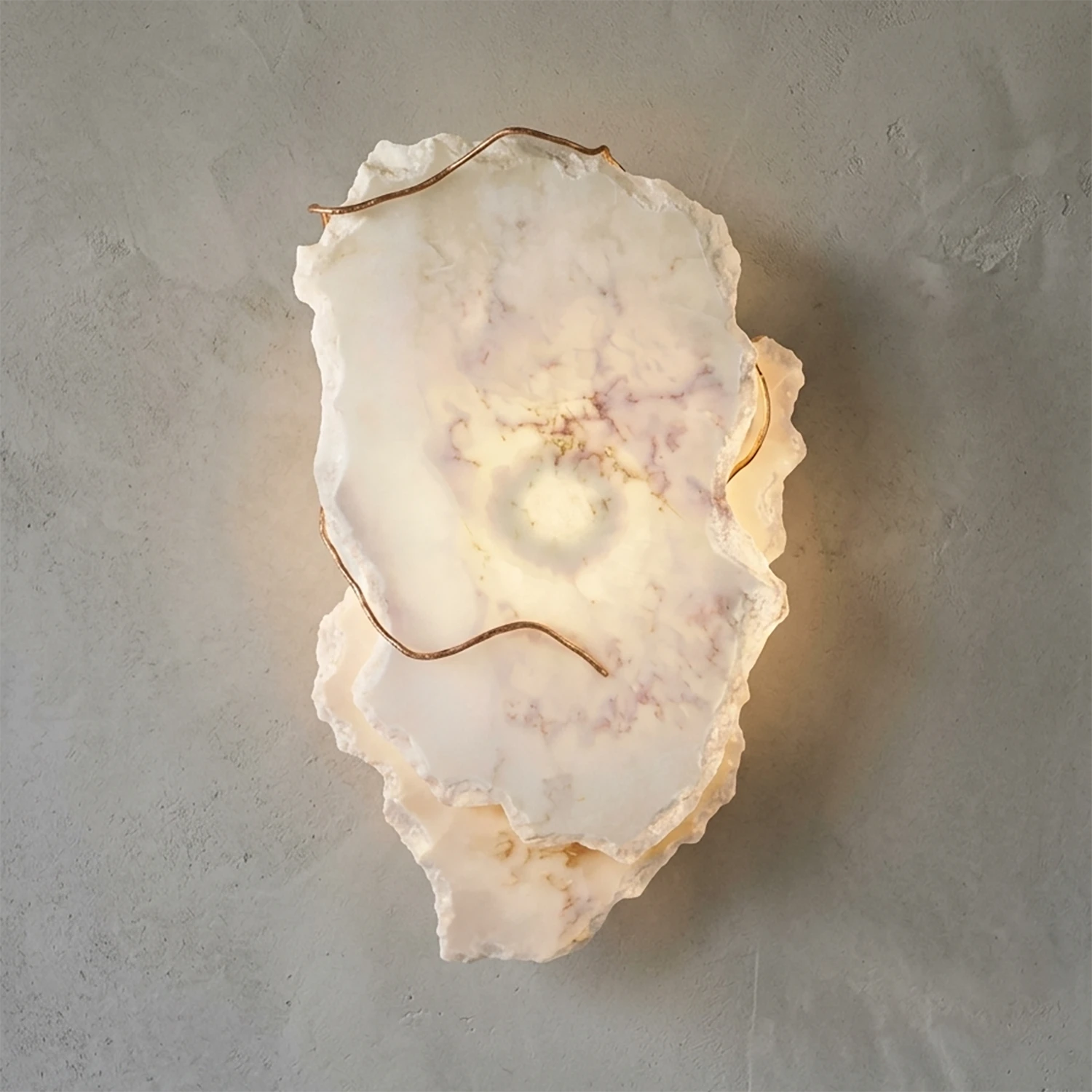Hand-carved alabaster wall sconce with warm glow and natural stone texture, modern luxury lighting