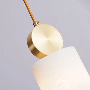 Angled view of the cylinder alabaster shade and its brushed brass cap