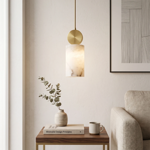 Brass-capped alabaster pendant hung low over a living room side table nook