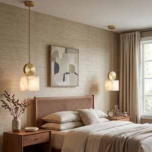 Two alabaster mini pendants hung either side of a bed as bedside lighting