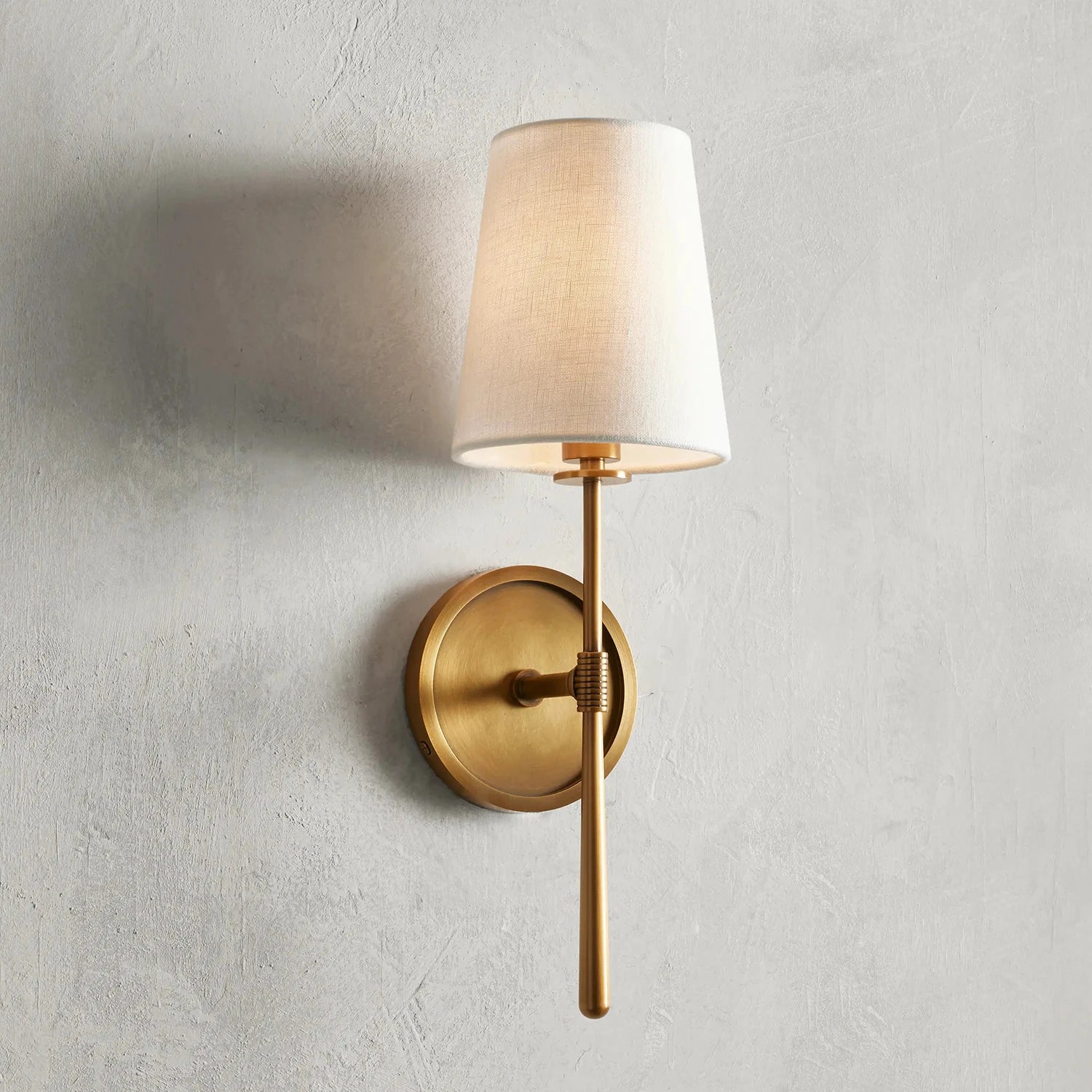 Rhoades Single Wall Sconce - Warm Glow on Plaster Wall | HoaiLamp