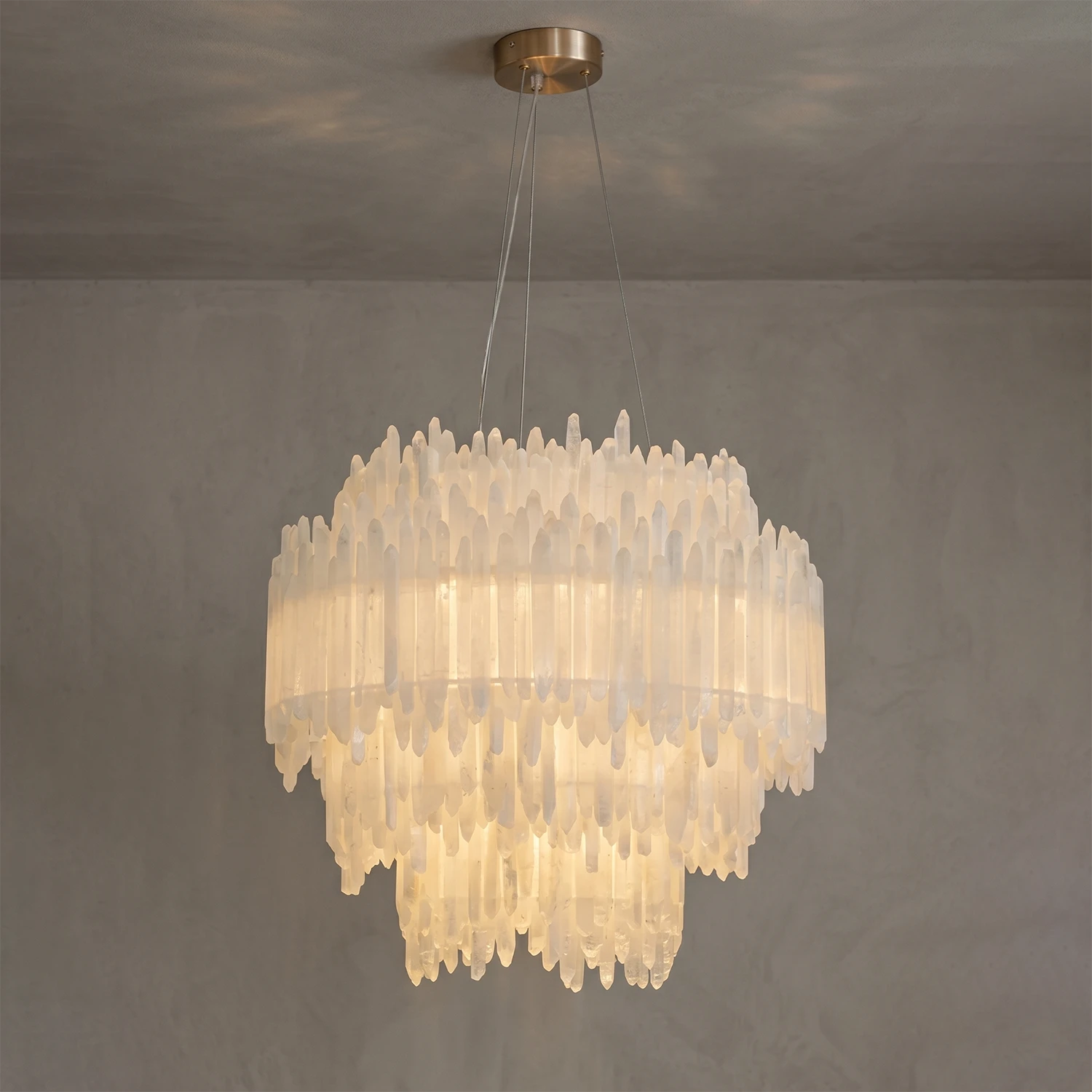 Luxury selenite layer pendant light featuring natural raw crystal layers glowing with warm ambient light.