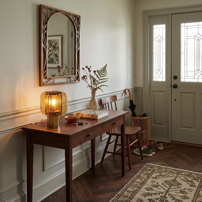 The Tramonto lamp lit on a foyer console in front of a wall mirror.