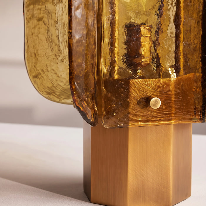 The octagonal base and a brass-tone pin fastening a glass panel.