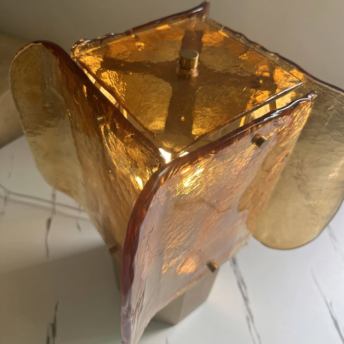 Top angle view of the amber glass plates crossing around the lantern.
