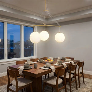 Triple Glass Orb Pendant Lamp-Bar Linear Chandelier - Formal Dining Room Long Wooden Table Evening Skyline Window | HoaiLamp